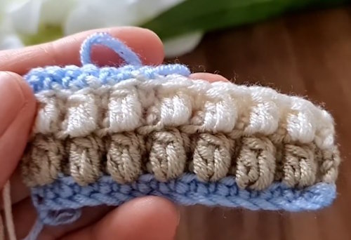 Easy crochet baby blanket pattern in progress using three pastel colors