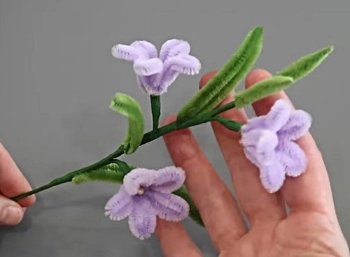 Hand holding a bunch of finished DIY Pipe Cleaner Starflowers