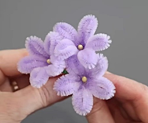 Three handmade DIY Pipe Cleaner Starflowers side by side