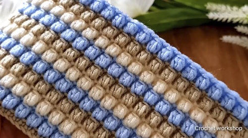 Easy crochet baby blanket pattern displayed in folded form