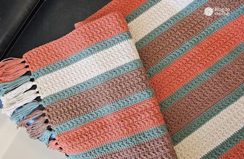 A top view of the blanket highlights the textured stitch and harmonious pattern.